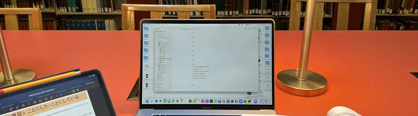 Student's study set up at a library with a computer on top of a desk.