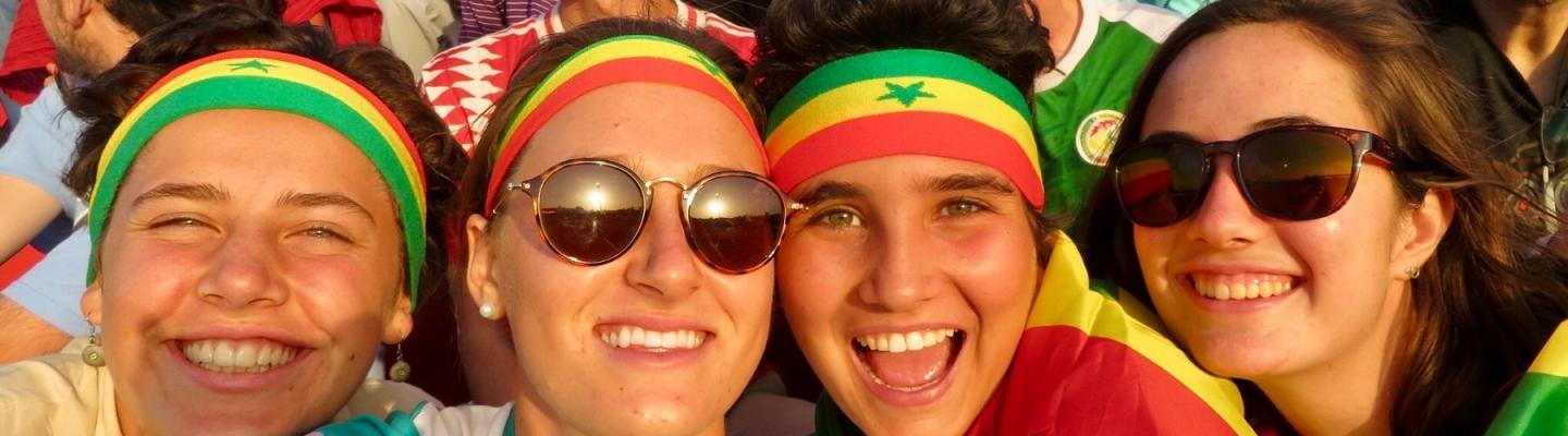 Kate with a group of friends wearing Senegalese flag colored headbands