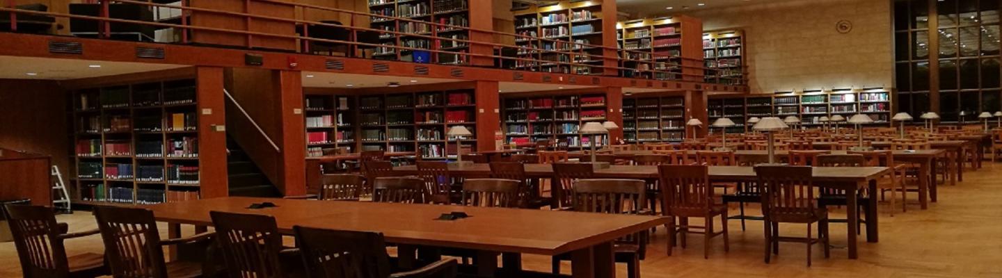 Photo of Trustee Reading Room in Firestone Library containing long, wooden desks and bookshelves