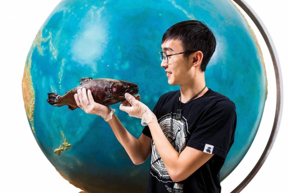 Student holding a fish