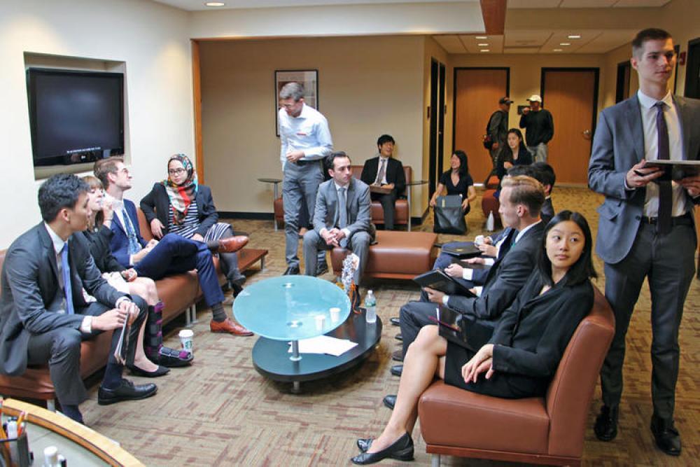 Students in business wear waiting for interviews
