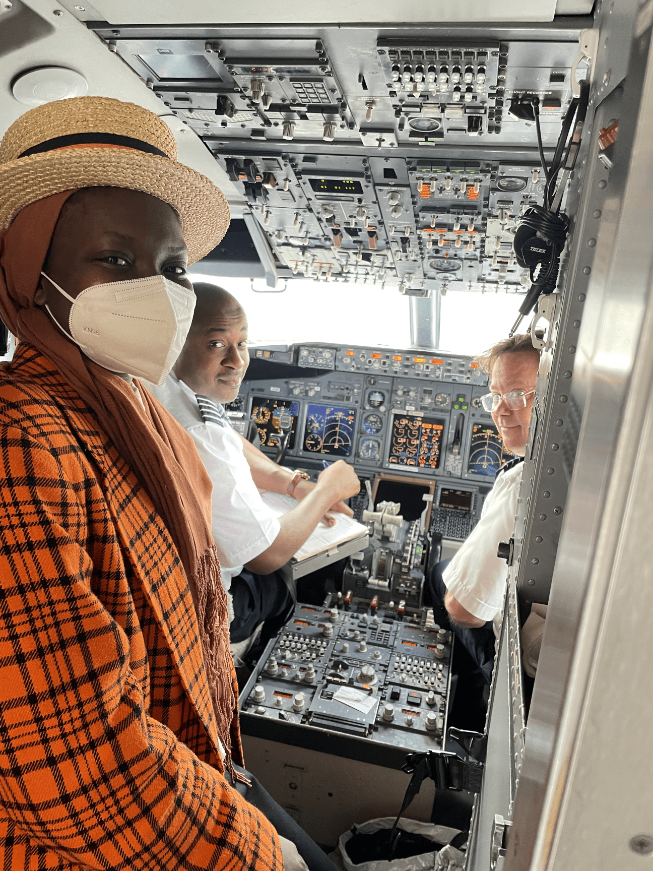 Aminah with pilots in the cockpit.