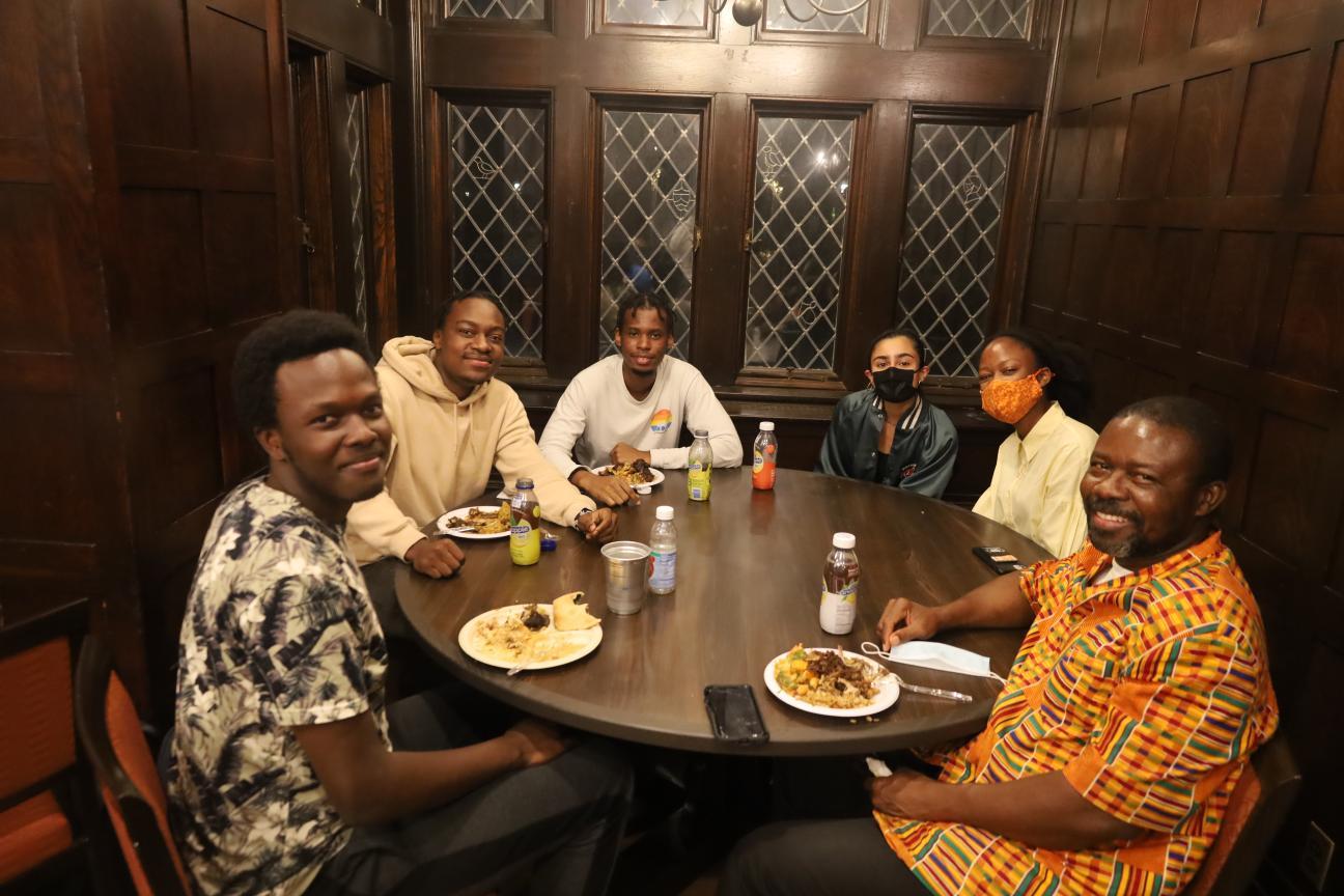 Members of PASA sitting around a table with food. 